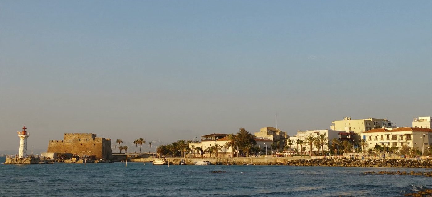 Paphos Harbour at golden hour, with the medieval castle and lighthouse